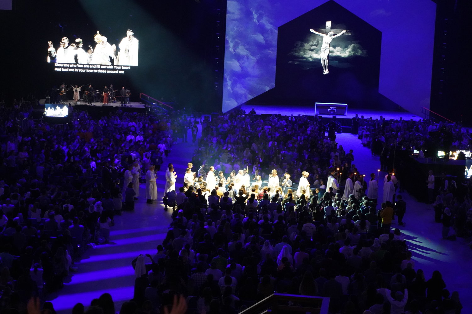 Priests carry the Most Blessed Sacrament around the floor and through the crowd in the Dome at the America’s Center in St. Louis Jan. 6 during Adoration attended by over 17,000 people during the SEEK23 conference organized by the Fellowship of Catholic University Students (FOCUS).
